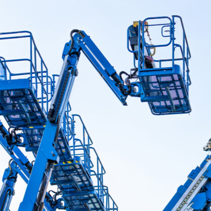 Contractor RentalsBlue boom lifts with extended arms and platforms are set against a clear sky. The machinery appears ready for construction work, conveying a sense of industrial readiness.